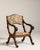 A traditional oak armchair featuring tapestry upholstery, reflecting the decorative arts tradition of integrating textile...