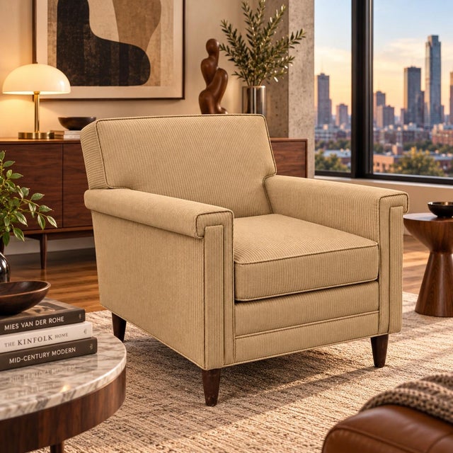This upholstered 1950s armchair features a tailored, striped gold fabric with squared architectural arms and a loose seat...