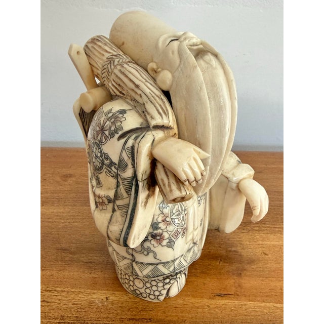 Antique Chinese carved immortal figurine of Shou Lao, who represents longevity, holding his peach-wood staff with a fan...