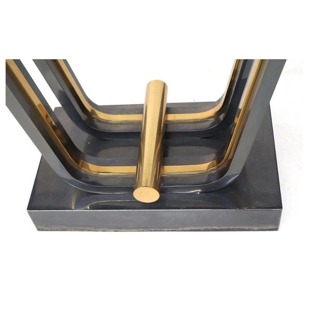 A vintage Art Deco style console table featuring a thick rectangular glass top with softly rounded corners set over a...