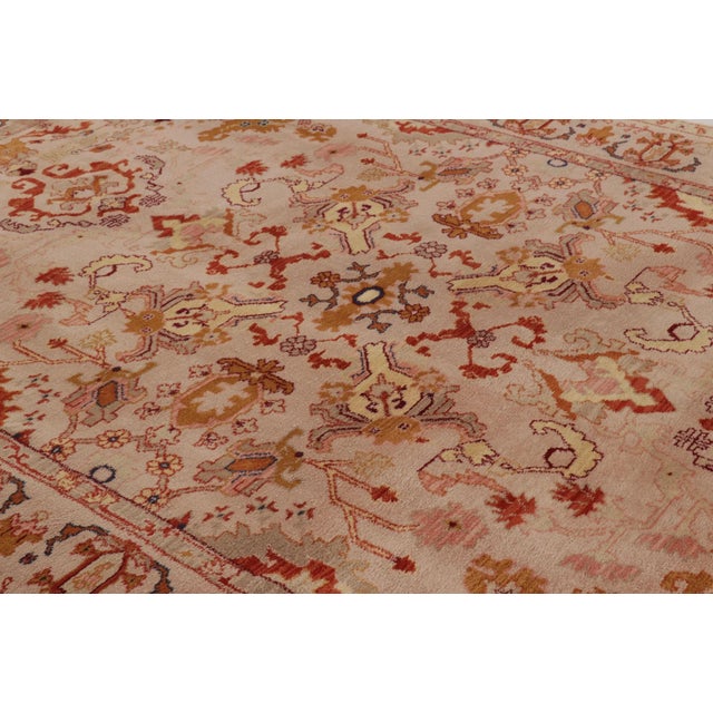 This 8x12 vintage Oushak rug is hand-knotted in wool, featuring an elegant floral medallion design framed by a spacious...