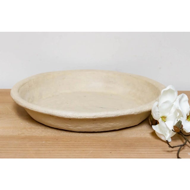 A lovely handmade from papier-mache for a touch of rustic charm, this handcrafted aged white round plate boasts surprising...