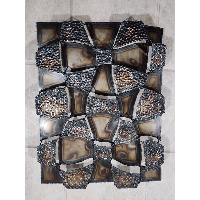 This striking vintage Brutalist-style metal wall sculpture is a bold statement piece featuring dimensional geometric...