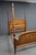 A substantial Pulaski Furniture quarter-sawn oak poster bed with a dramatic four-poster design. The headboard and...