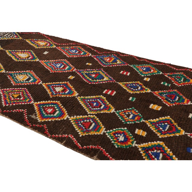 Hand-knotted in wool and originating from Morocco circa 1950-1960, this 4x10 vintage Moroccan rug is an extremely rare...