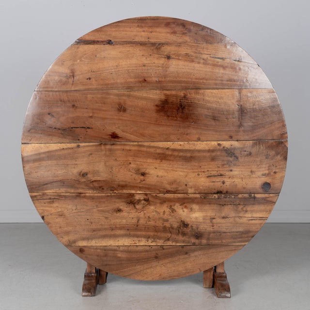 A 19th century Country French wine tasting, or tilt-top table made of solid walnut. Nice grain and character to the wood...