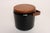 Stylish ice bucket in black patent vinyl with solid teakwood lid and sculptural handle and off-white plastic insulated...