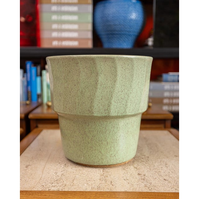 Dimensions: 10.75” H x 11.5” D Substantial ceramic planter in a soft sage green glaze with fine speckling throughout....