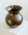 This vintage brass vase from the 1960s features a striking spherical form crowned by an elegant wavy rim, creating a...