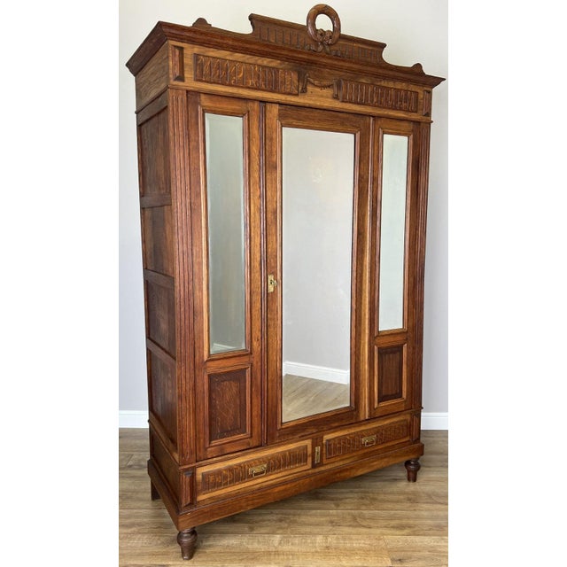 A stunning Antique French oak mirrored wardrobe featuring elegant proportions, beautifully detailed craftsmanship and...