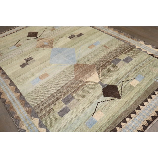 a mid-20th-century Persian gabbeh geometric rug in earthy blues, browns, and green Details rug no. j4473 size 6' 10" x 9'...