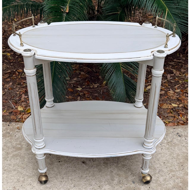 Handsome Swedish gustavian style rolling bar cart. Two tiers for great storage of your barware. This barcart is sturdy and...