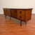 Vintage teak sideboard that features book-matched grain, fantastic afromosia (African teak) round recessed pulls with...