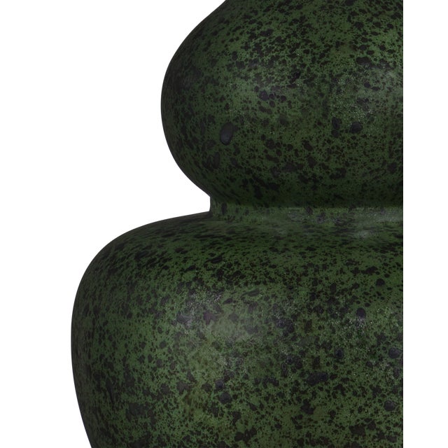 The splatter finish on the double-gourd-shaped body of the Kinnaird Table Lamp brings the green lamp the feeling that it...