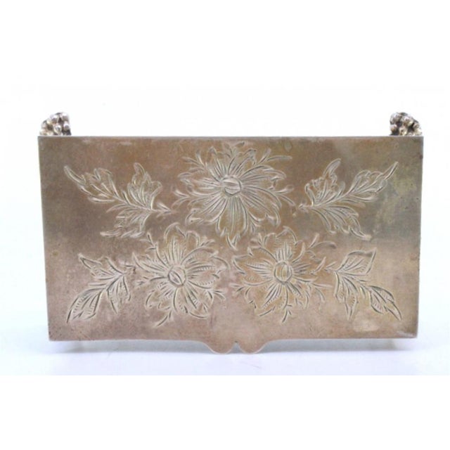 Silver Jewelry Box with Floral Motifs Engraved on the Lid and Resting on Four Claw-Shaped Feet, in Good conditions....