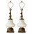 A striking and rare pair of mid-century Hollywood Regency table lamps crafted with oversized opaline glass urn fonts...