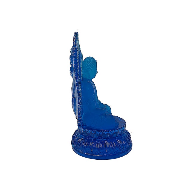 This exquisite sculpture is meticulously crafted from vibrant blue crystal glass, capturing a serene figure of Buddha...