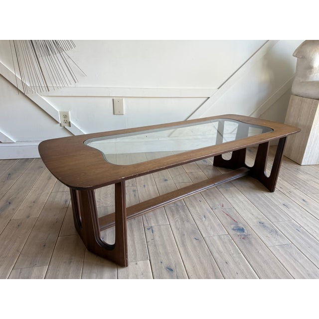 A Bassett mid century modern walnut coffee table after Adrian Pearsall with an organic and sculptural shape top, base and...