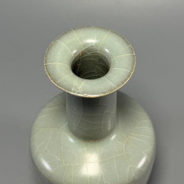Fine antique Chinese celadon roll‑neck vase. Straight cylindrical body paired with tall slender neck, covered in beautiful...
