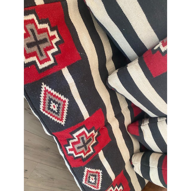 Reminiscent of the George Smith Kilim Sofas, this unique leather sofa nods to a more southwest theme. Pillows are thick...