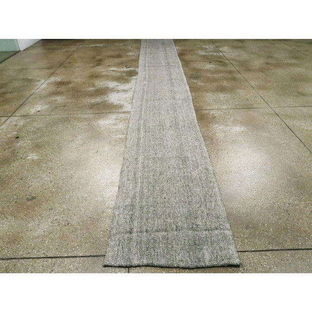 A vintage Turkish flatweave Kilim runner handmade during the mid-20th century. Measures: 2' 4" x 37' 3"