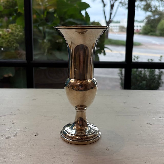 A sophisticated pair of sterling silver vases, each standing 6.5 inches tall with a refined silhouette. The generous 3...