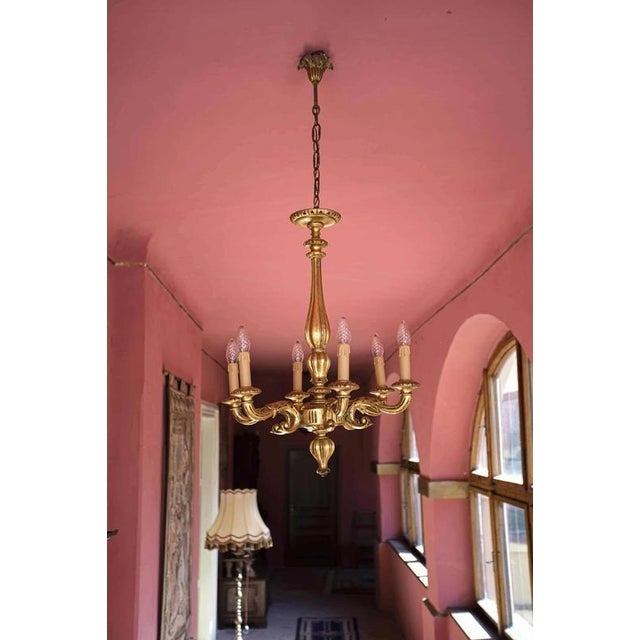 Antique chandelier made of gilded wood. Completely restored: new copper wiring, new lampholders, new lampshades. Date:...