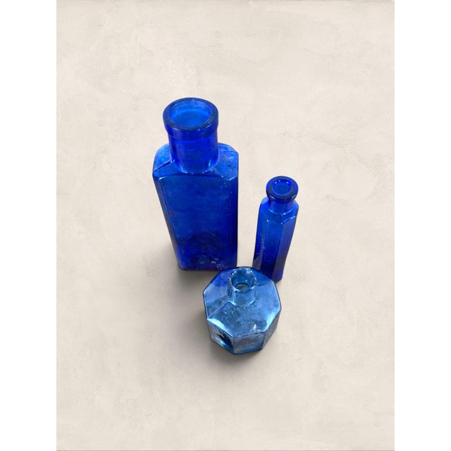 Antique Set of Three English Cobalt Blue Glass Apothecary Bottles A charming set of three antique English cobalt blue...