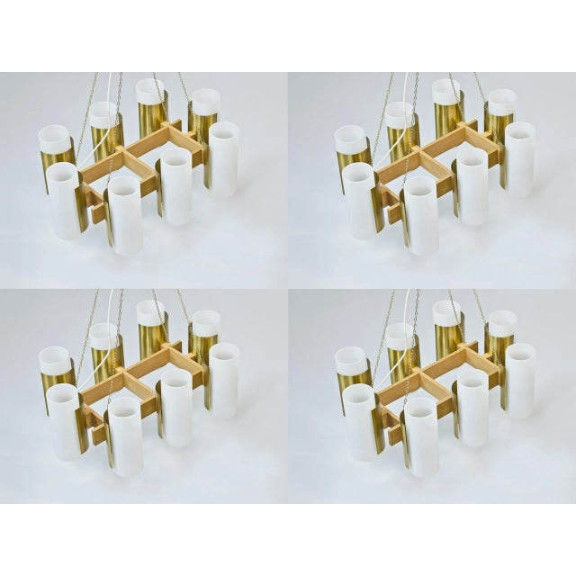 Unique set of four chandeliers designed by sten carlquist during the 1950s. Solid oak with dull polished brass diffusers...