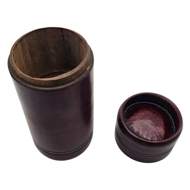 A Japanese bamboo tea canister defined by its cylindrical form and naturally banded structure, reflecting utilitarian...