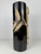 Stylish ceramic vase with a sleek, cylindrical design in glossy black. The vase is decoratively finished with a refined...