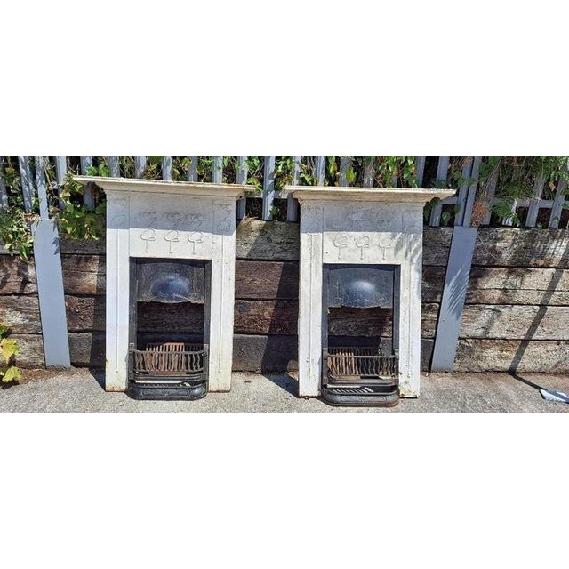 An exceptional matching pair of tall original art nouveau cast iron combination fireplaces, dating precisely to 1906 and...