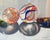 Light Diversions 2 by Wendy Carney | Oil on linen panel Still life of marbles and crayons For Sale