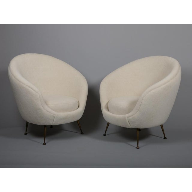 Chic pair of 1950s egg shaped Italian armchairs. Brass legs. Beautifully curved chairs upholstered in an alpaca wool velvet