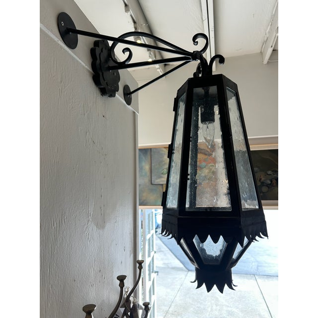 Pair of vintage wall-mounted lantern sconces in a tapered pineapple-inspired form with metal frames and seeded glass...