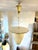 A vintage pendant light with an elegant and timeless design, typical of the 1950s, characterized by balanced lines and...