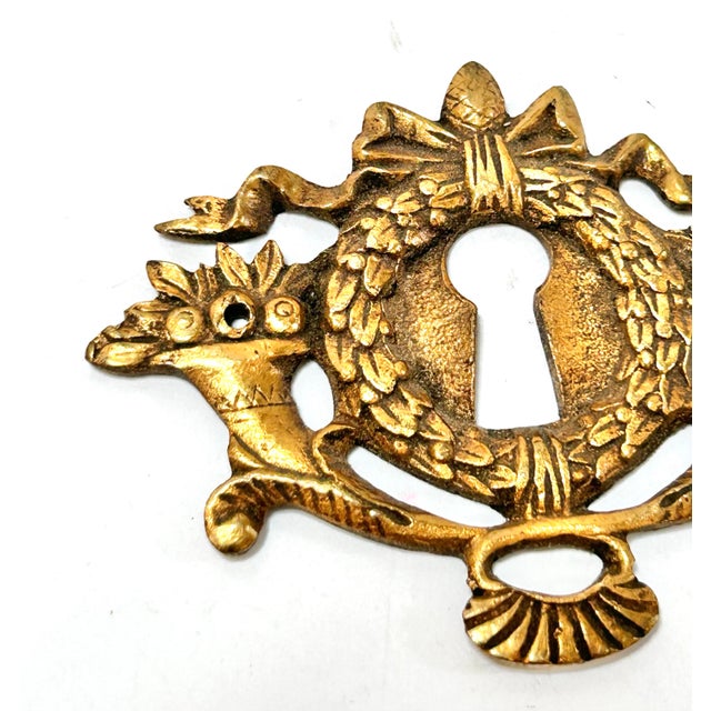 A beautiful keyhole meant to embellish a piece of antique furniture. Would also look lovely on an antique wooden box....