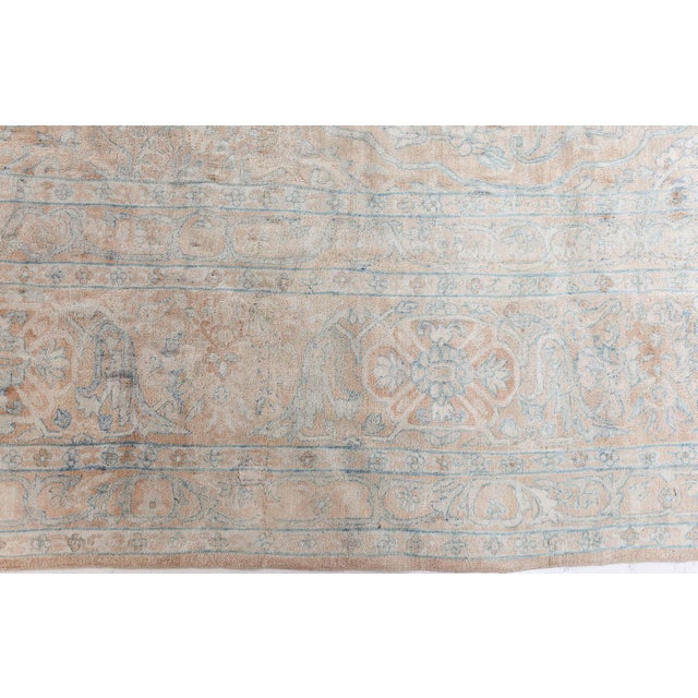 This exquisite antique Persian Kirman rug is a testament to the regions renowned weaving tradition, showcasing an...