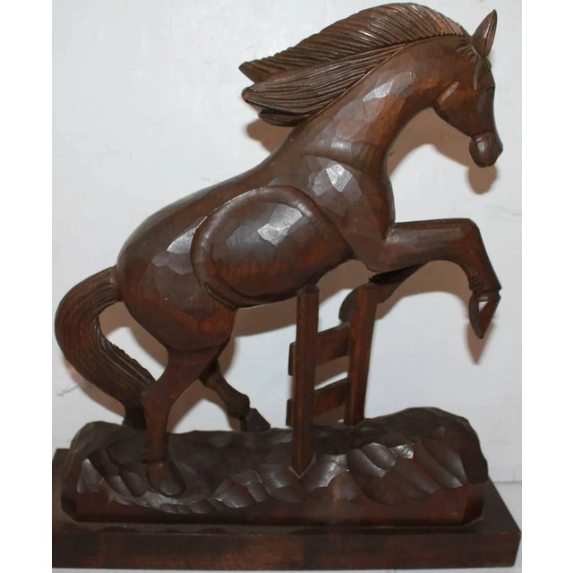 This wonderful hand-carved horse is riding and performing tricks. The Folk Art carving is unsigned. The maker is unknown.