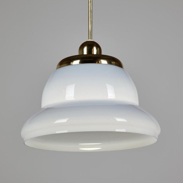 German Veb Narva bell-shaped pendant from the 1970s. The glass and metal surfaces of the lamp have scratches and wear in...