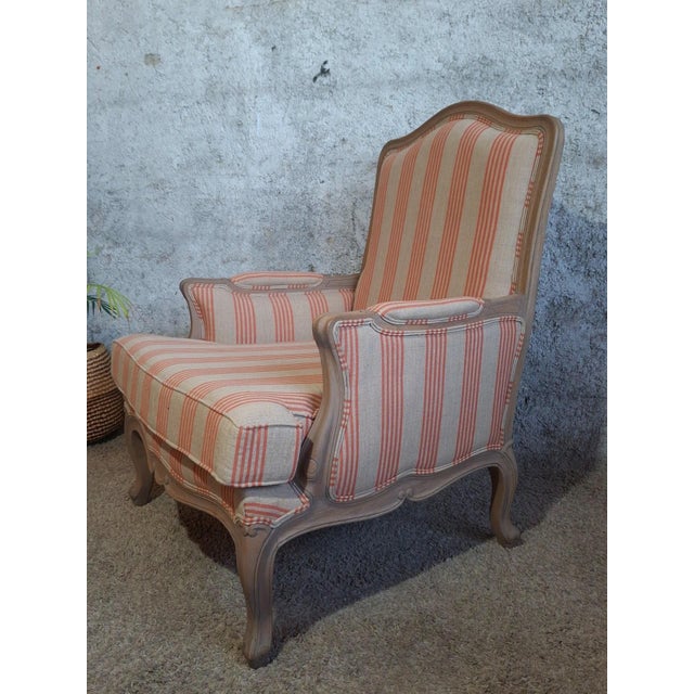 An elegant louis xv style bergère armchair, combining period charm with contemporary freshness in a particularly...
