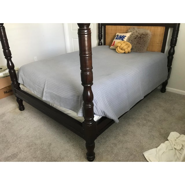Carved mahogany four poster queen bed frame with caning to headboard. An exquisite piece! Quality hardwood construction to...