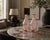 Pair of French pink glass carafes dating to the 1960s, with an Art Deco-inspired silhouette. Each has a shaped body...