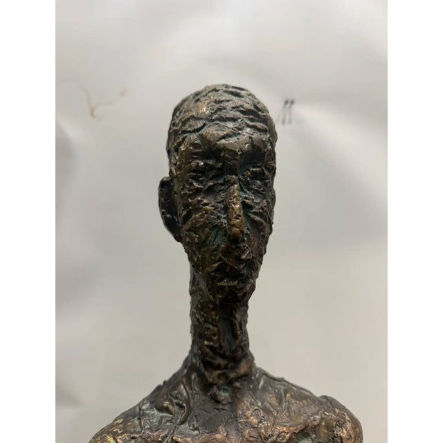 Monumental Patinated Fiberglass Figure in the Style of Alberto Giacometti A monumental fiberglass sculpture with a bronze...