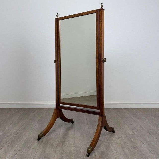 An exceptionally well-crafted early 20th-century English Edwardian cheval mirror, finely constructed in richly figured...