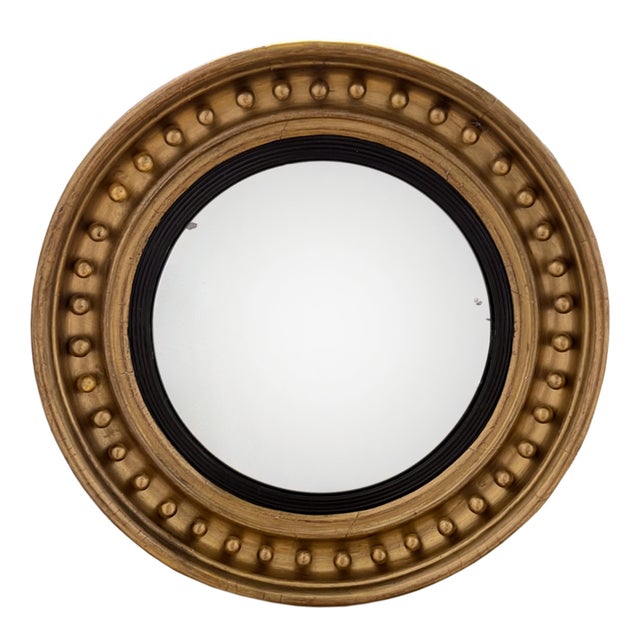 A lovely decorative English convex mirror. The giltwood frame is decorated with regularly spaced balls. The original plate...