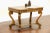 A library table or writing desk from the early 1900's was carved Mahogany in the Empire style with curving scrolled legs....