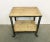 Industrial table from the 1960s. It features an iron construction,a four original wheels and a solid wooden plate. The...