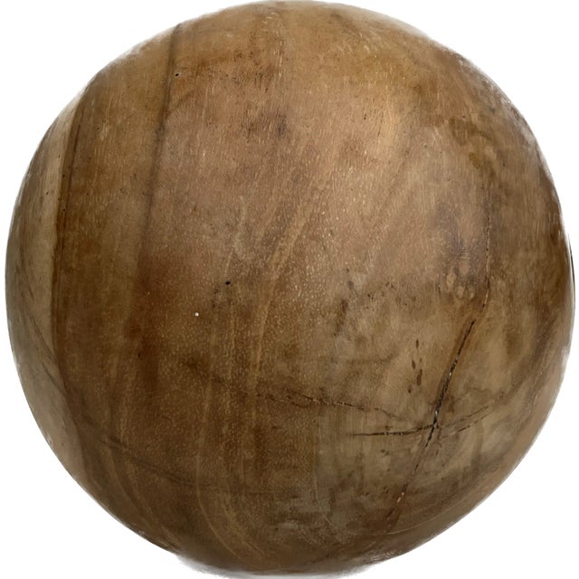 Carved from solid teak with visible knots and graining, a small, decorative ball is the perfect accessory for bringing a...