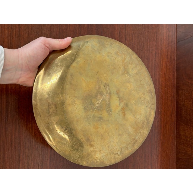 Cast bronze plate with abstract relief decorations, 1960s. Dimensions: diameter 27.5 cm.